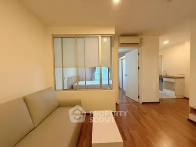 Modern living room with wooden flooring and open kitchen layout