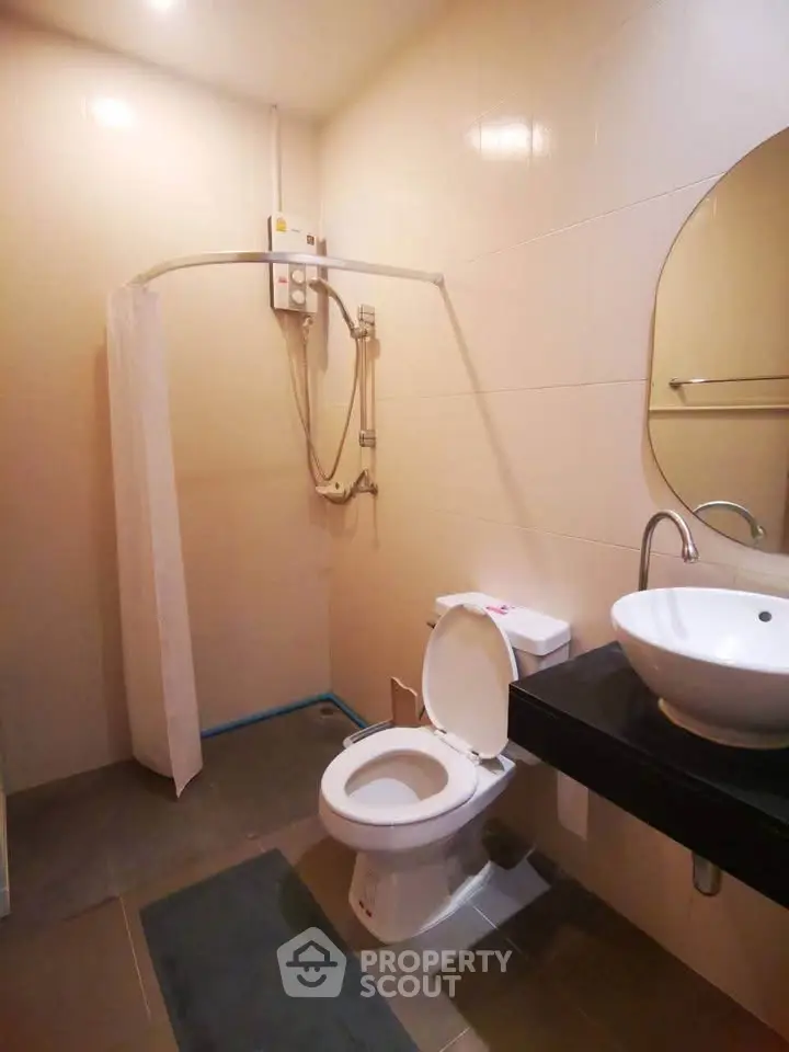 Modern bathroom with shower and sleek fixtures in contemporary apartment.