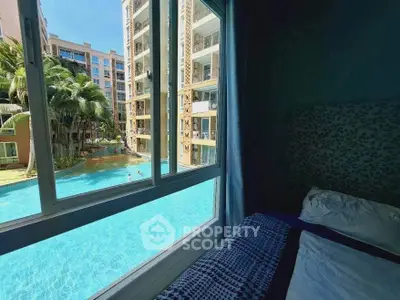 Luxurious bedroom with stunning pool view in modern apartment complex