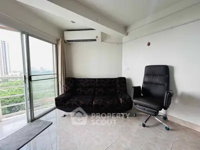 Modern living room with balcony view and stylish furniture in high-rise apartment.