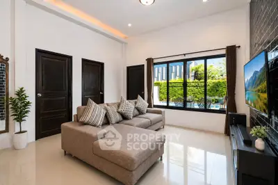 Spacious living room with modern decor and pool view, perfect for relaxation and entertainment.