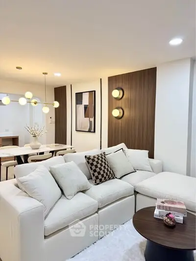 Elegant living room with modern decor and cozy seating area, perfect for relaxation and entertaining.