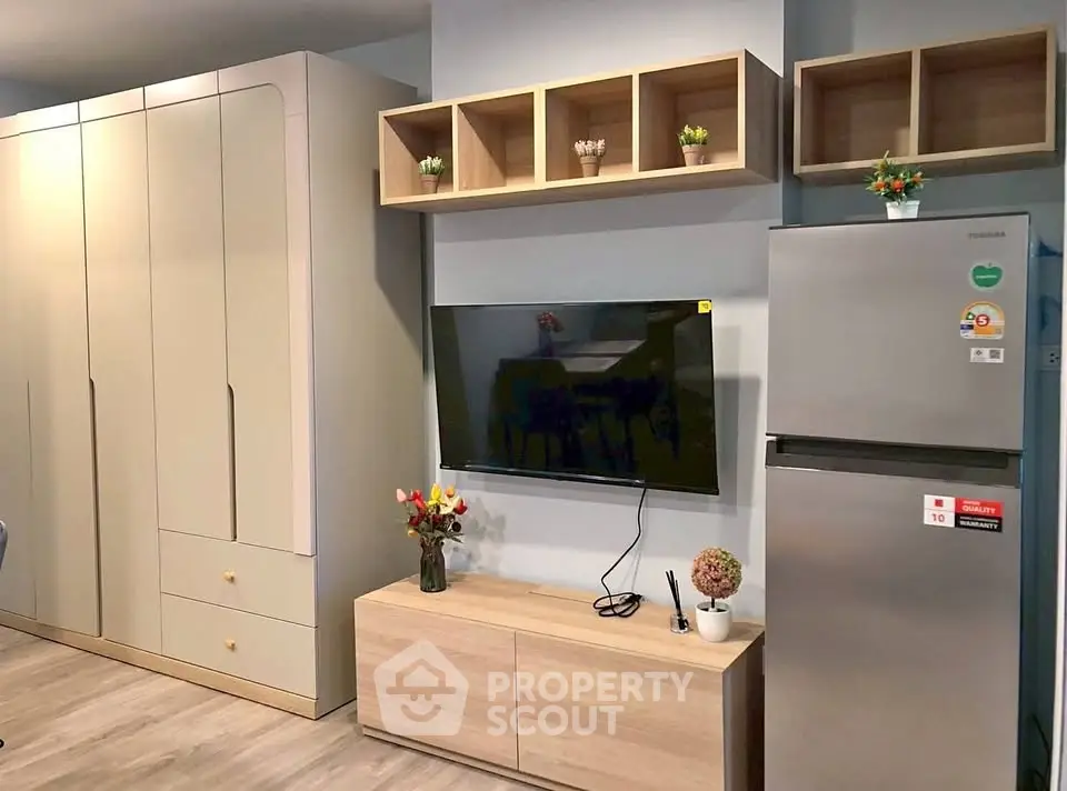 Modern living room with sleek TV setup and stylish storage solutions.