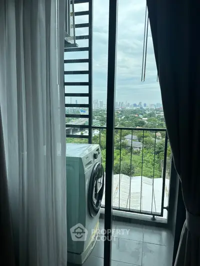 Charming balcony with city view and washing machine, perfect for urban living.