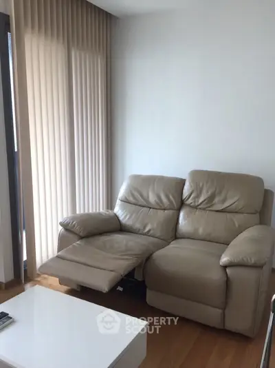Cozy living room with beige leather recliner and modern decor