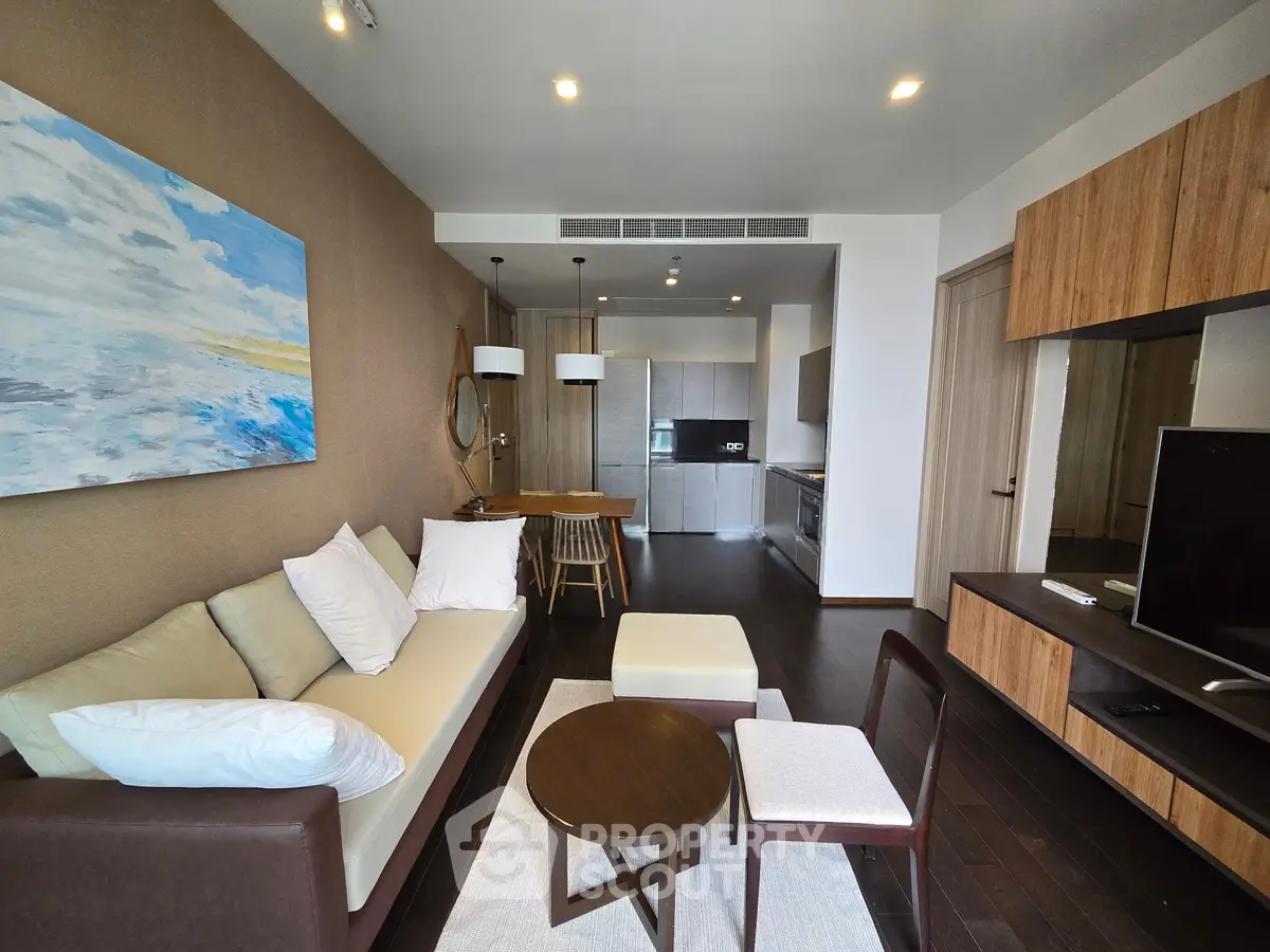 Modern living room with stylish furniture and open kitchen layout