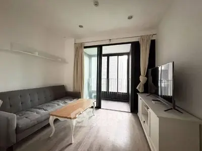 Modern living room with balcony access and stylish furniture