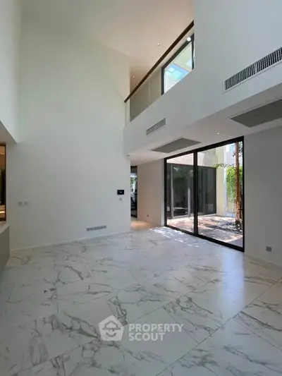 Spacious modern living room with high ceilings and marble flooring