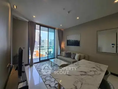 Modern living room with city view, elegant decor, and natural light in luxury apartment.