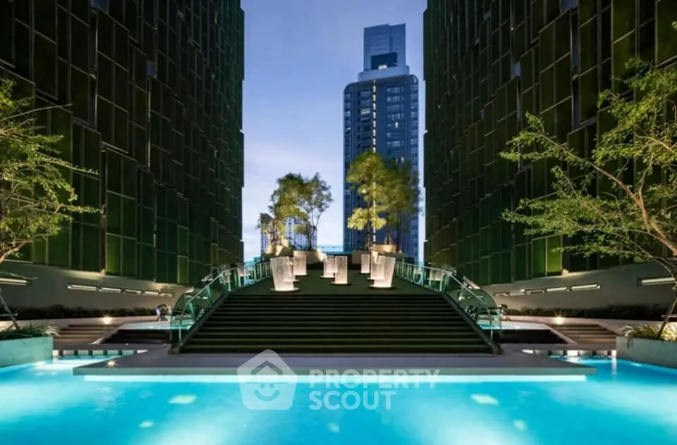 Luxurious modern building with stunning pool and elegant architecture at dusk.