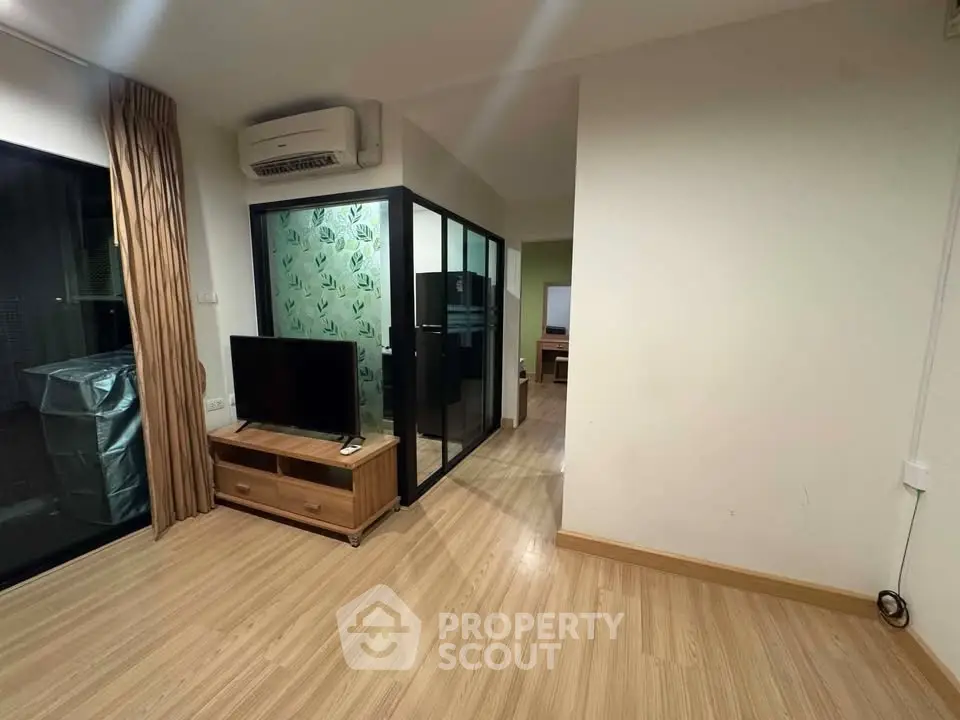 Modern living room with glass partition and wooden flooring
