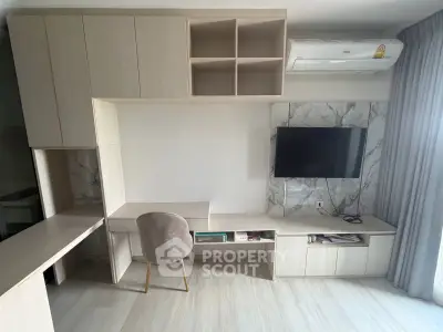 Modern living room with built-in storage, TV, and air conditioning, featuring sleek design and neutral tones.