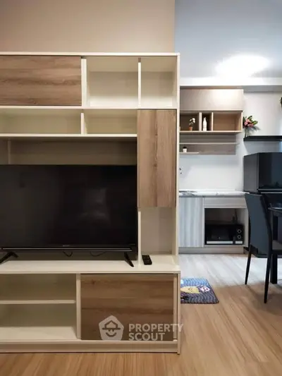 Modern living room with sleek TV unit and stylish kitchen area