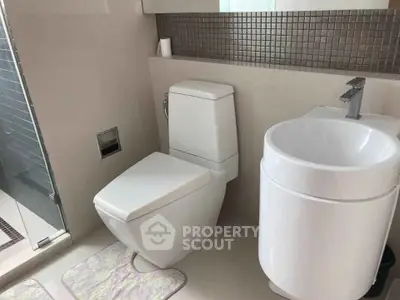 Modern bathroom with sleek fixtures and glass shower enclosure