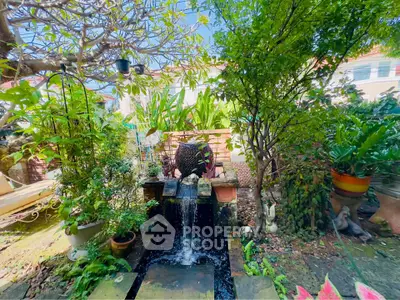 Charming garden oasis with lush greenery and tranquil water feature