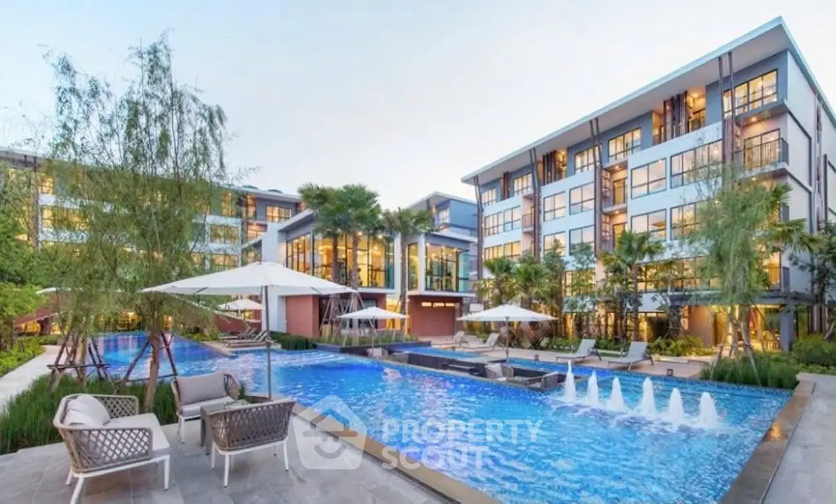 Luxurious apartment complex with stunning pool and modern architecture.
