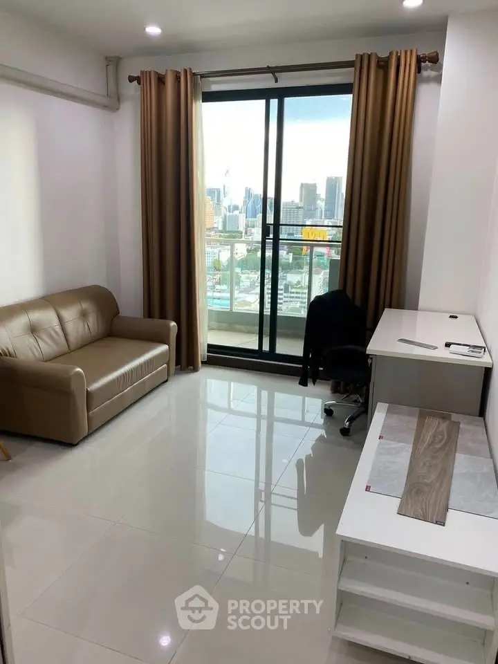 Modern living room with city view, featuring sleek furniture and large windows for natural light.