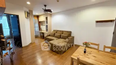 Spacious living room with cozy sectional sofa and wooden dining set, perfect for relaxation and entertaining.