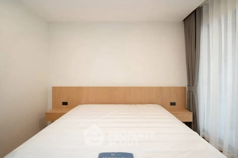 Minimalist bedroom with large window and modern design
