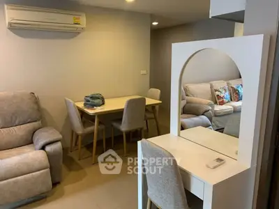 Cozy living room with modern furniture and dining area, perfect for relaxation and entertaining.