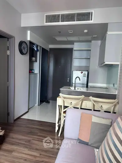 Modern open-layout kitchen with stylish decor and cozy living area