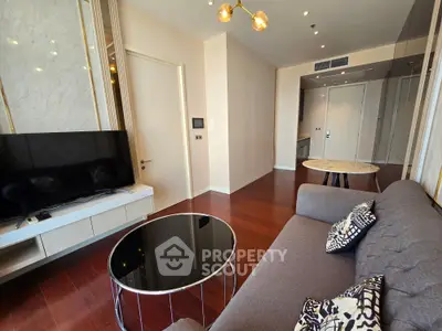 Modern living room with stylish decor and open layout, featuring a sleek TV setup and elegant lighting.