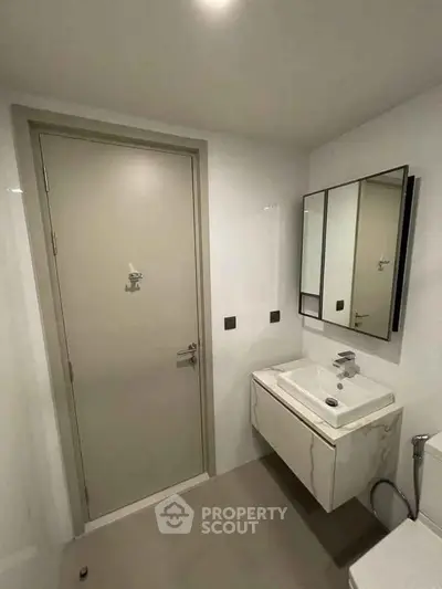 Modern bathroom with sleek sink and mirror in minimalist design
