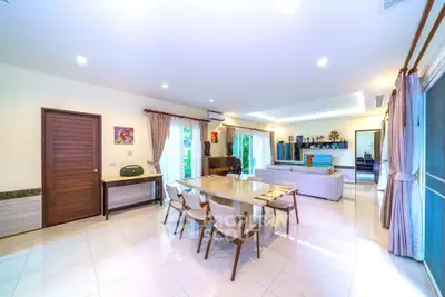 Spacious and bright living room with modern decor and large windows.