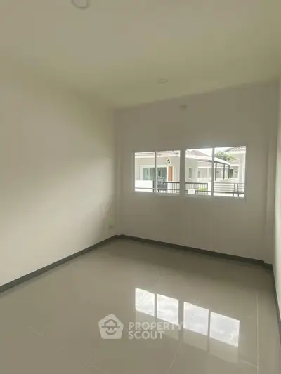 Bright empty room with large window and glossy tiled floor, perfect for customization.