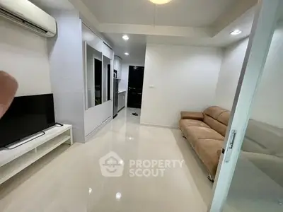 Modern living room with sleek design and comfortable seating in a bright apartment.