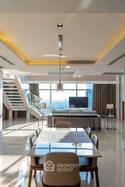 Luxurious open-plan living room with stunning city view and modern staircase