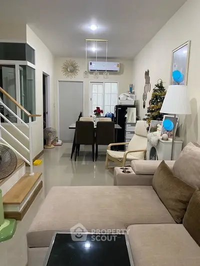 Cozy living room with modern decor and dining area in a stylish home.