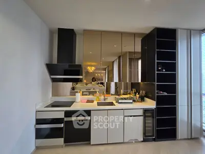 Modern kitchen with sleek cabinetry and built-in appliances in a stylish apartment