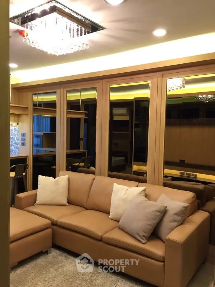 Luxurious living room with elegant lighting and plush leather sofa in modern apartment.