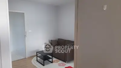 Cozy living room with modern sofa and coffee table in a minimalist apartment.