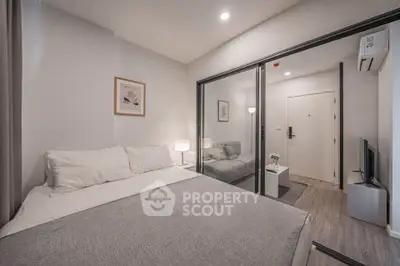 Modern bedroom with cozy decor and glass partition to living area