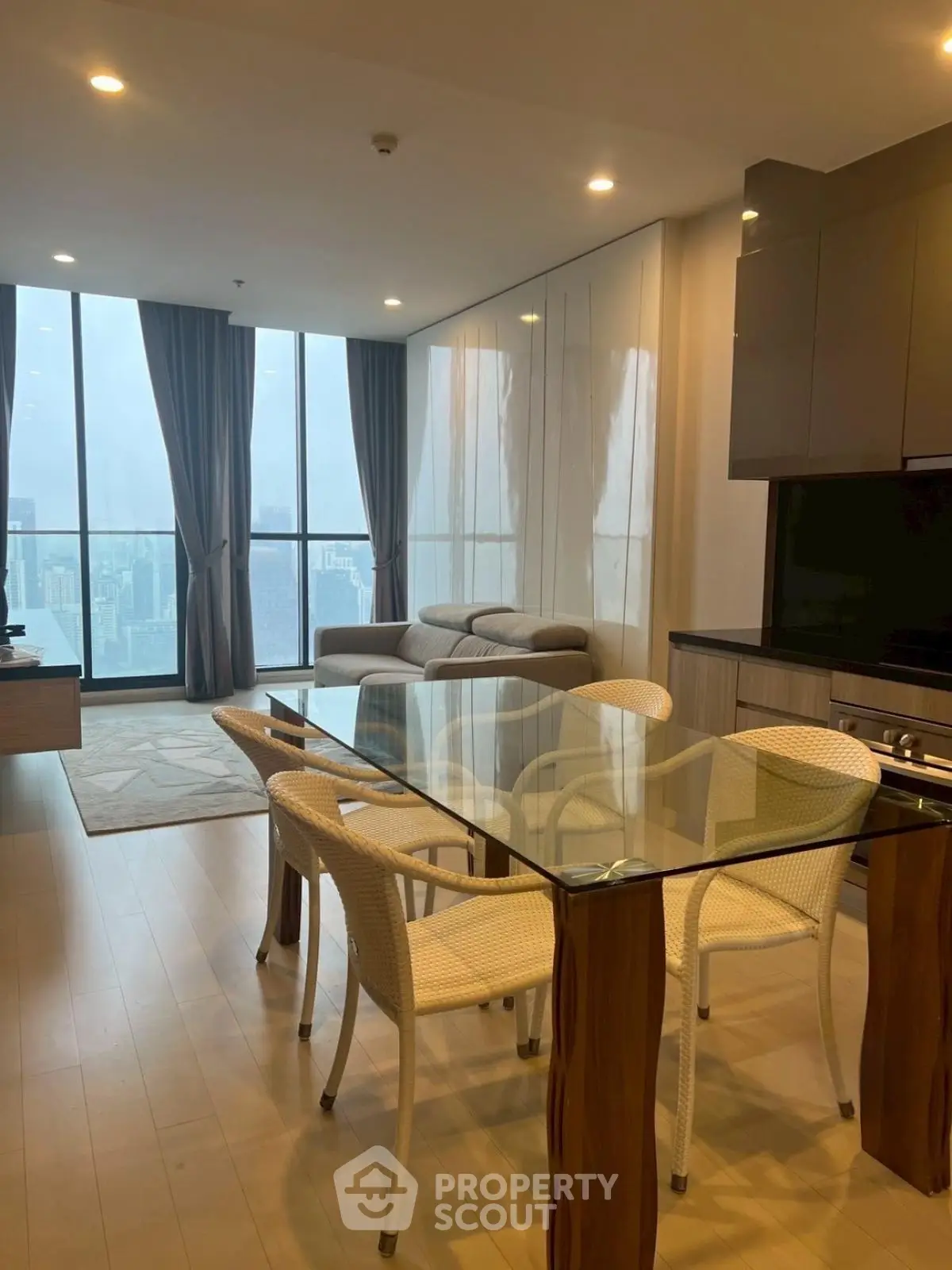Modern living room with glass dining table and city view