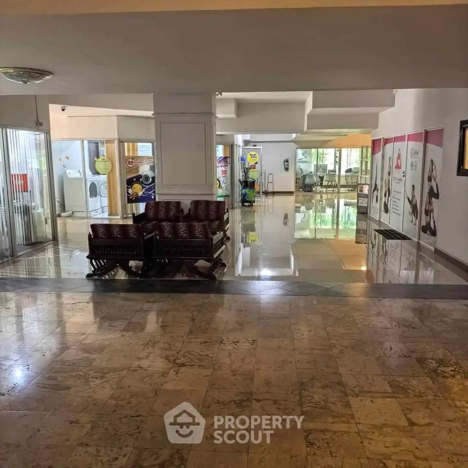 Spacious building lobby with polished floors and seating area, ideal for welcoming guests.