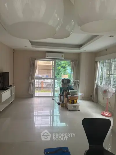 Spacious living room with modern decor and large windows for natural light.