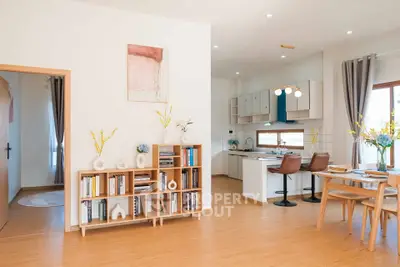 Modern open-plan living room and kitchen with stylish decor and natural light