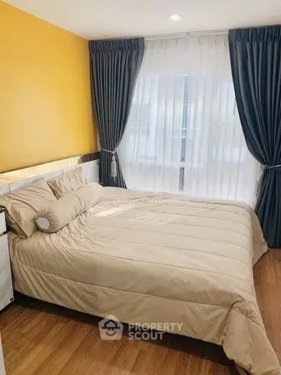 Cozy bedroom with elegant curtains and warm lighting, perfect for relaxation.