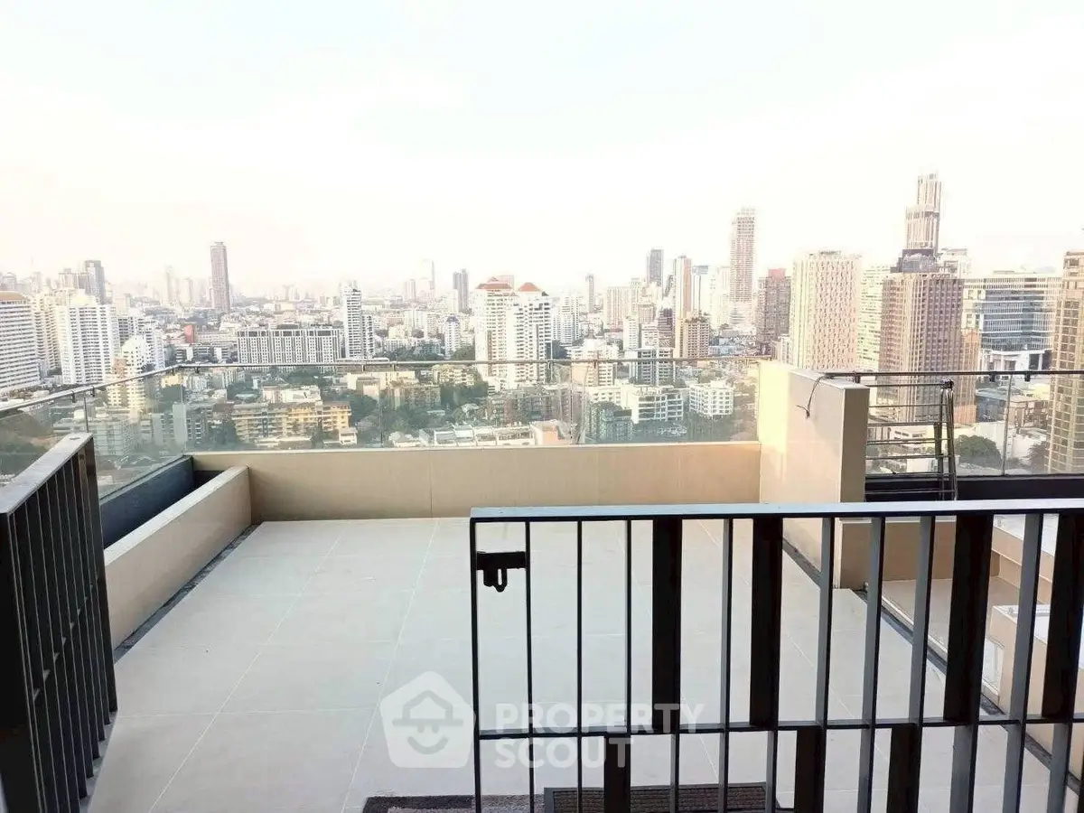 Stunning rooftop view of city skyline from modern apartment balcony.