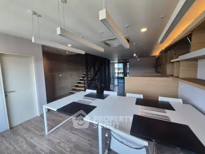 Modern open-plan living space with sleek design and ample natural light.