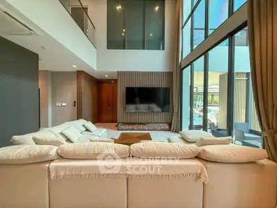Luxurious modern living room with high ceilings and large windows