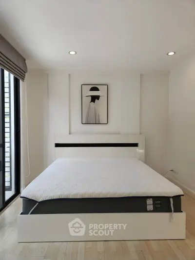 Modern minimalist bedroom with stylish decor and natural light