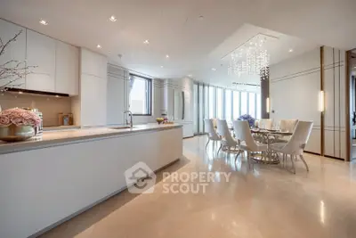 Luxurious open-plan kitchen and dining area with elegant lighting and modern design.