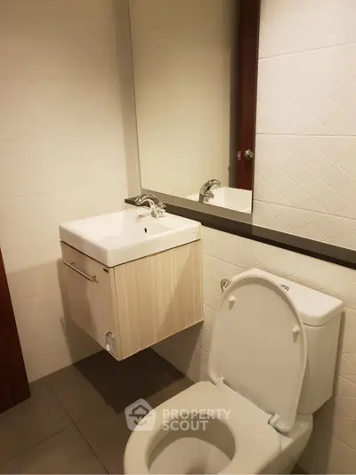 Modern bathroom with sleek fixtures and wall-mounted sink
