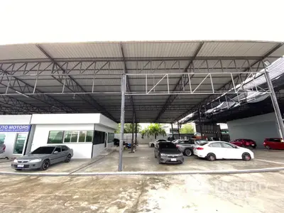 Spacious covered parking area with multiple cars and modern steel structure.