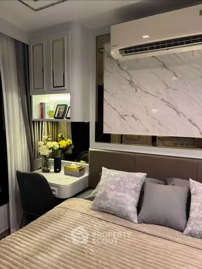 Luxurious bedroom with elegant decor and cozy ambiance, featuring a stylish desk and plush bedding.