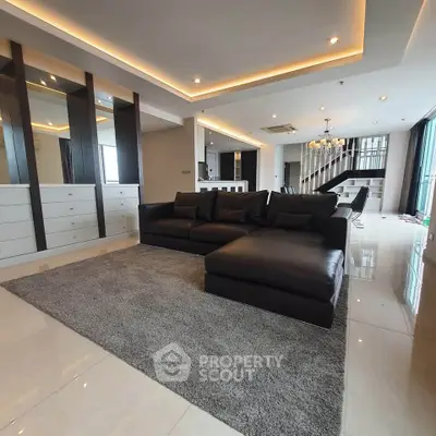 Luxurious modern living room with sleek black sofa and elegant lighting
